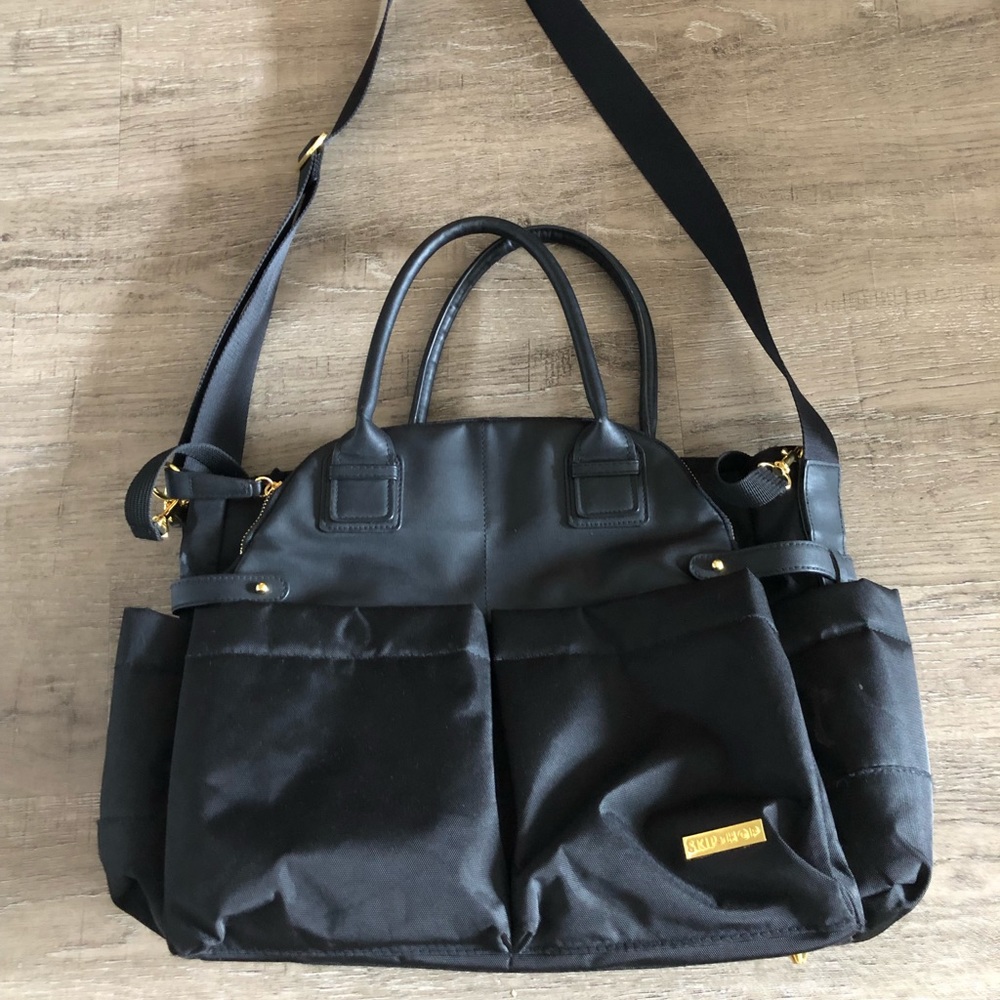 Black SkipHop diaper bag with changing pad